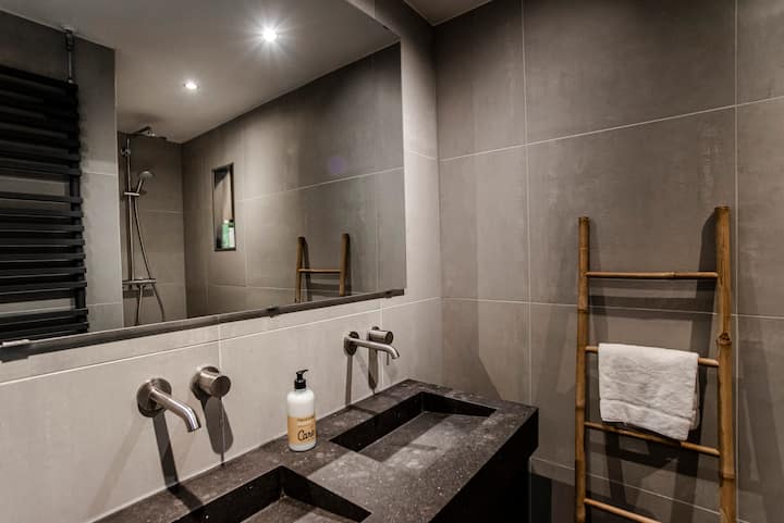 Modern bathroom with dark stone double sink