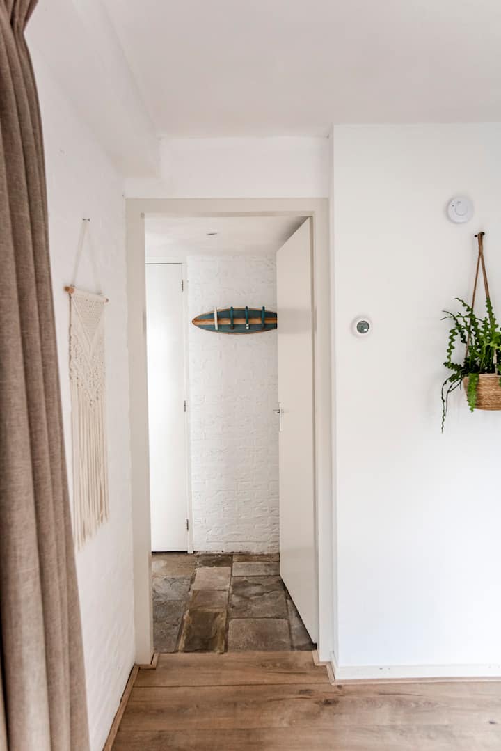 Hallway with surfboard hooks and coastal decor