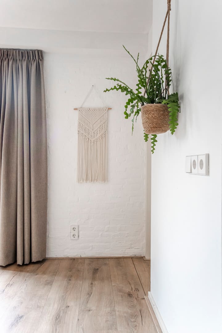 Corner detail with macrame wall hanging and plants